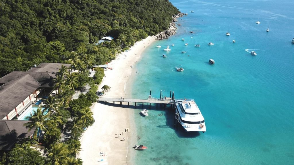 the ferry pulls up at welcome bay, fitzroy island, cairns